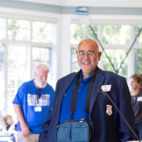 Former GVSU Rowing head coach John Bancheri walks towards podium